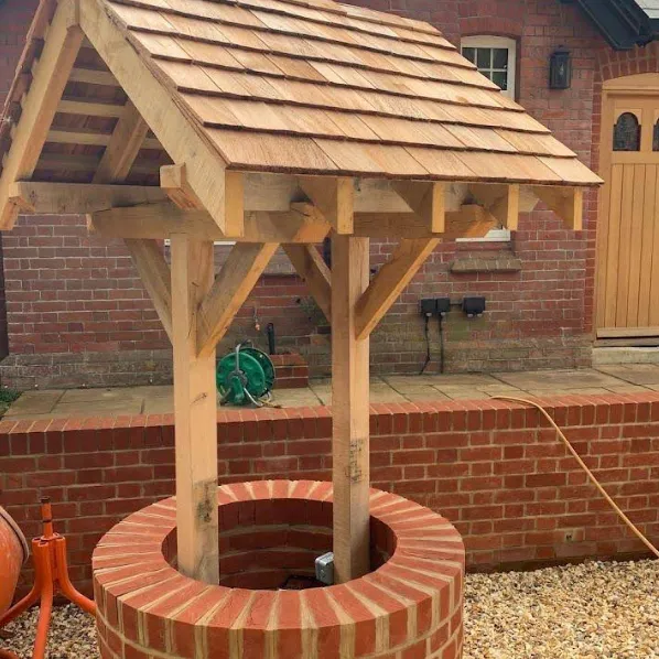 Round brick well with an oak frame and shingled timber roof